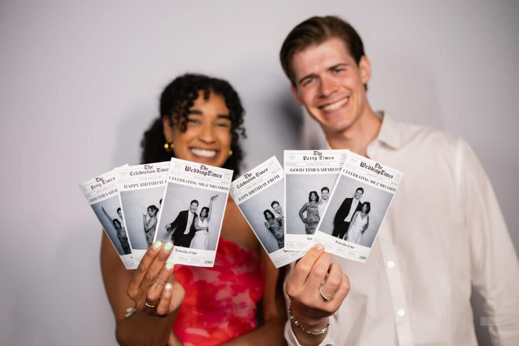Attendees posing at a Glam Booth with luxurious props and a stylish backdrop.