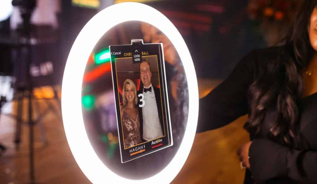 Guests having fun and taking photos at a Drop-Off Booth during a corporate or party event.