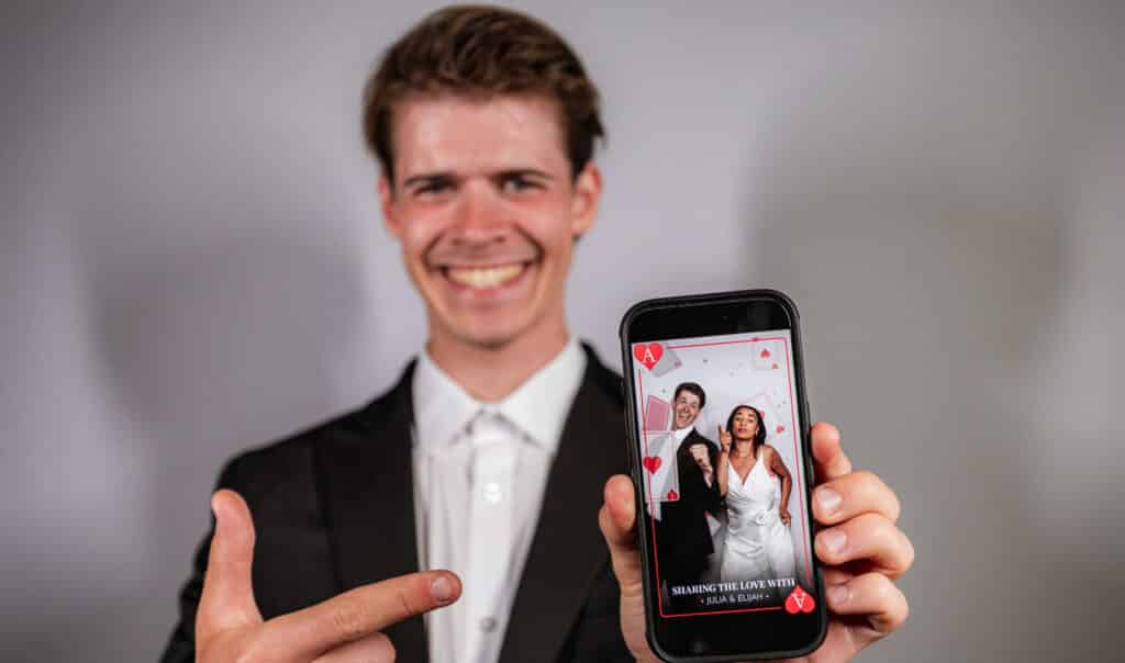 A wedding event with an Ace of Hearts theme, capturing the bride and guests in photos.