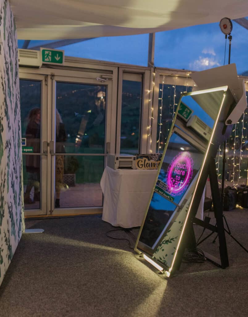 Guests enjoying a Magic Mirror Booth at a wedding, party, or corporate event, taking interactive photos.