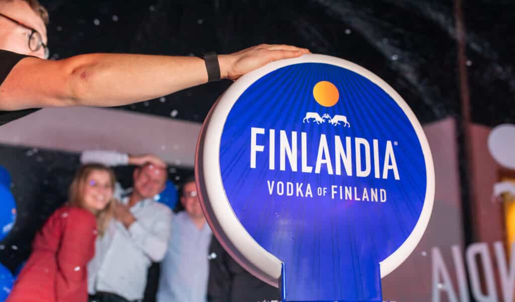 Guests enjoying a branded booth experience at a corporate event, posing for photos.