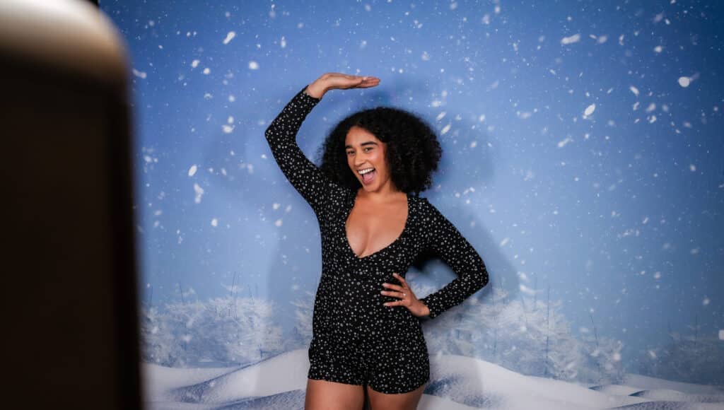 Guests enjoying holiday-themed photo booths and festive activities at an event.
