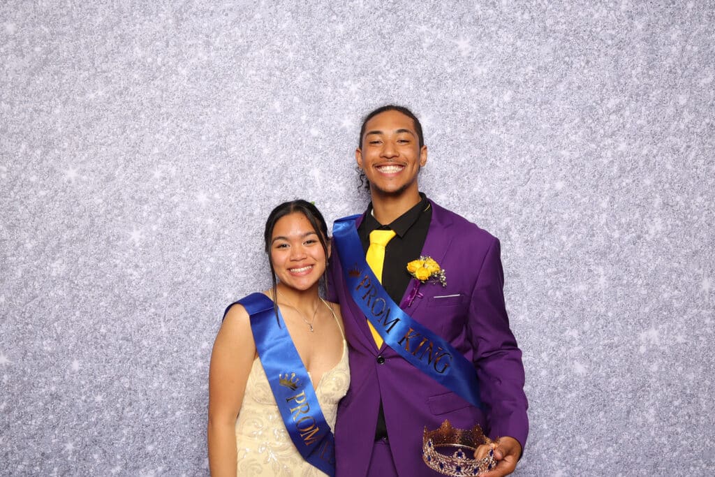 Students dressed up and posing for photos during a festive prom celebration.