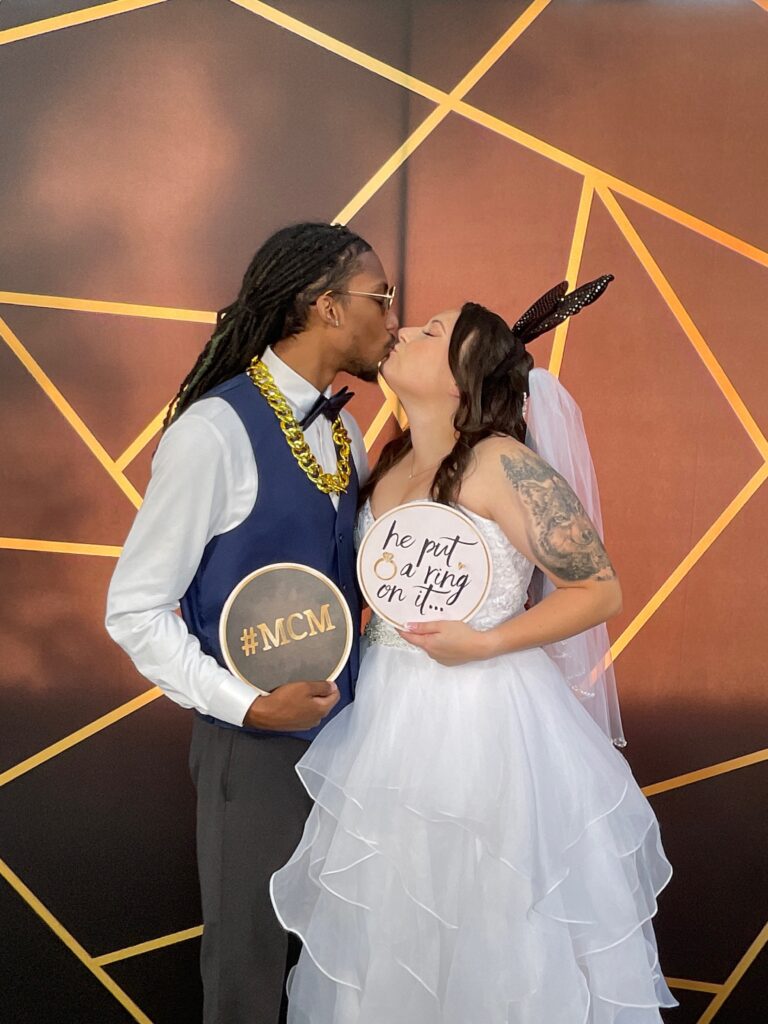 Guests posing for photos and enjoying the festivities at a wedding event.