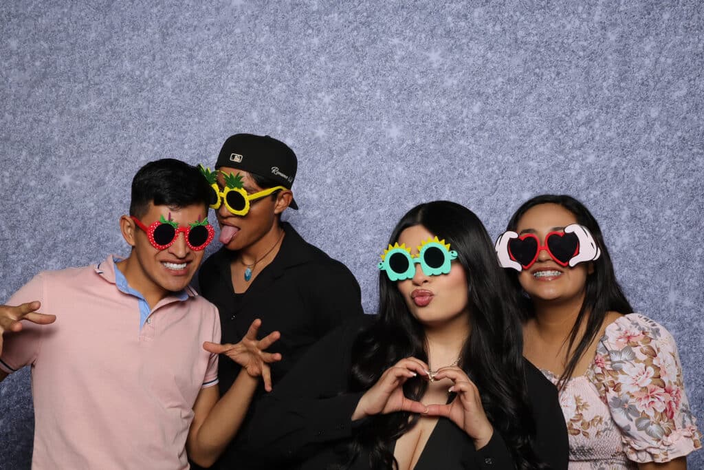 Guests celebrating a Quinceañera with festive decorations and photo opportunities.