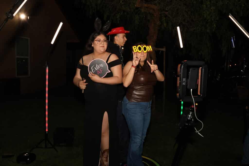 Attendees capturing memorable moments during a Quinceañera party.