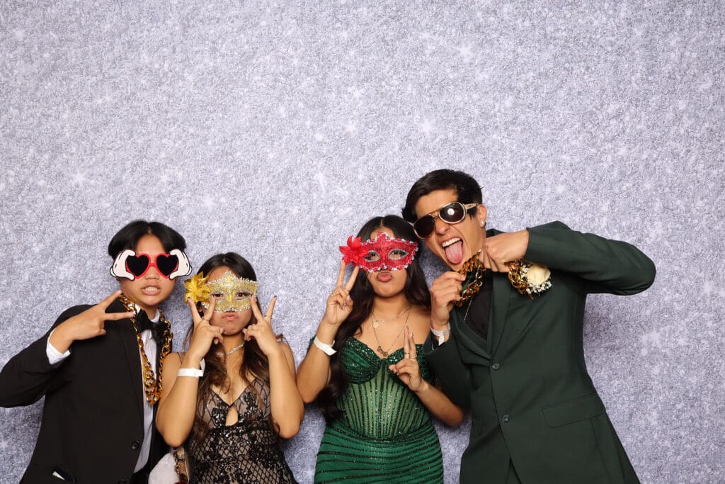 Students posing together for pictures during an elegant prom event.