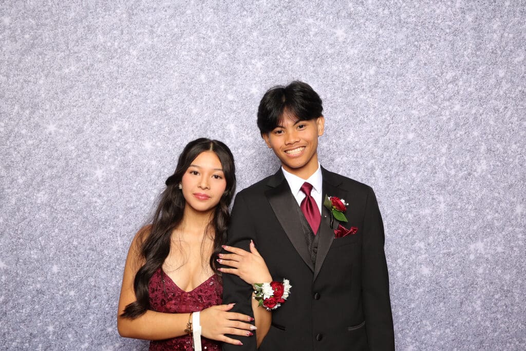Students dressed up and posing for photos during a lively prom celebration.