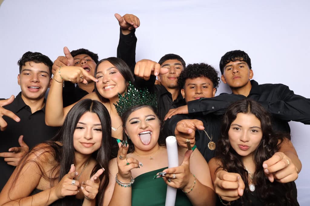 A joyful Quinceañera party with family and friends capturing special moments.