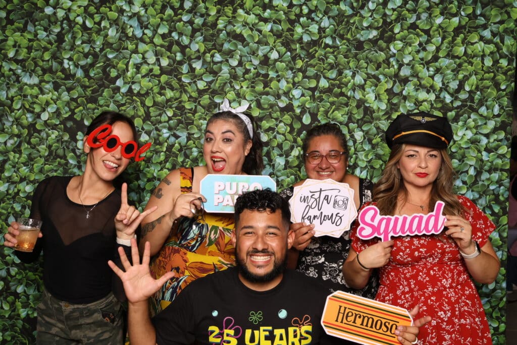 Group of guests posing together during a holiday party celebration.