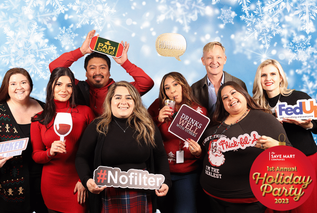 Guests celebrating at the Save Mart event with festive holiday decorations.