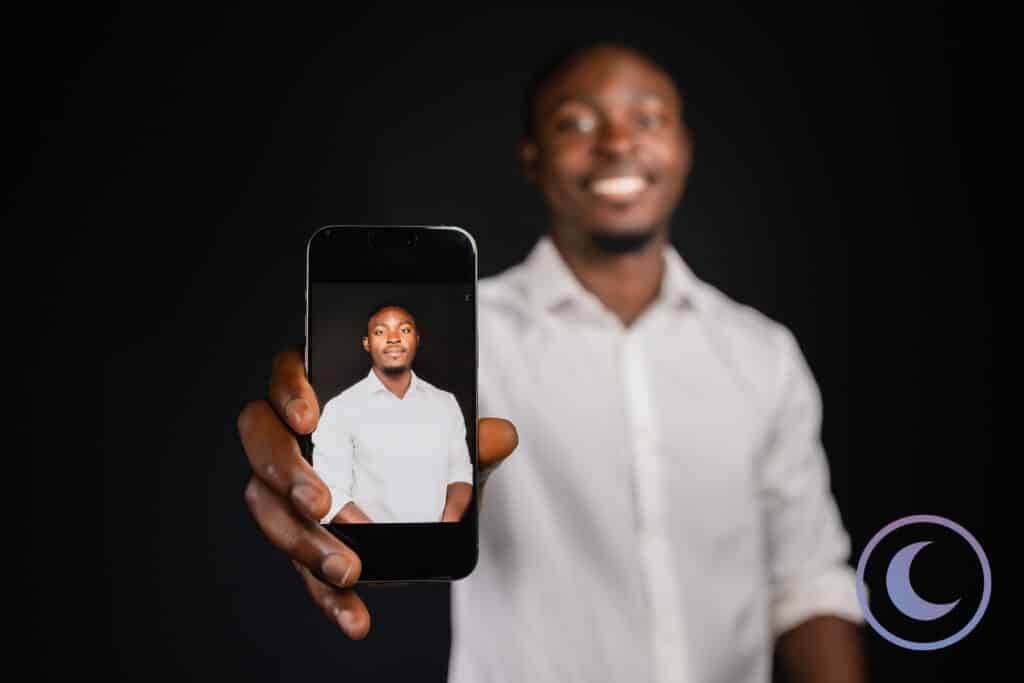 Man showing his professional portrait on phone screen taken with Luna Events Headshot Booth