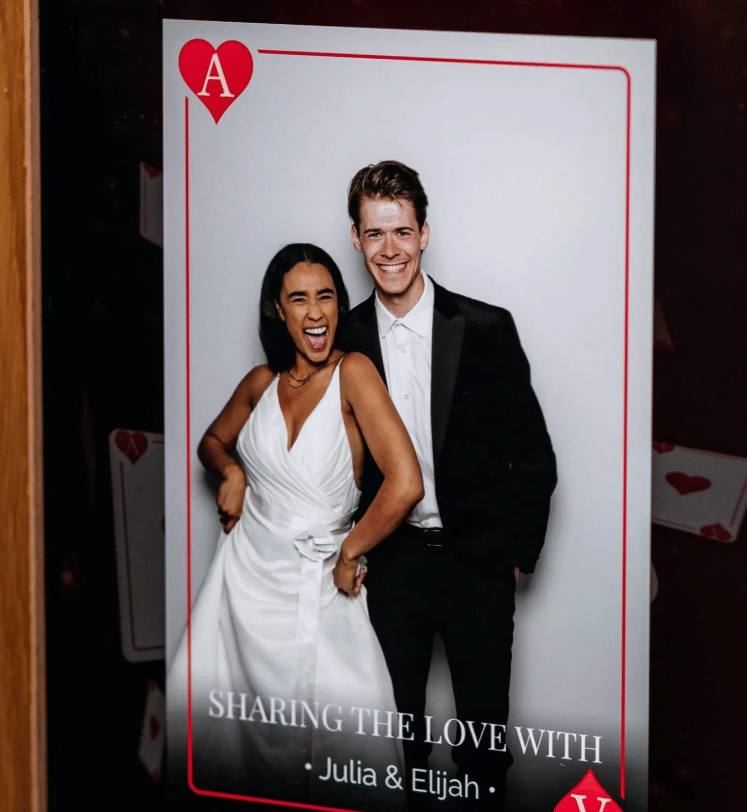 Guests celebrating and taking photos at an Ace of Hearts-themed event.