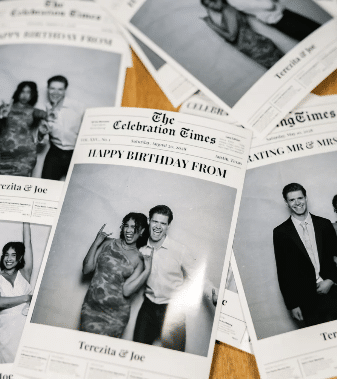 Guests having fun and posing for photos at a Newspaper Booth setup.