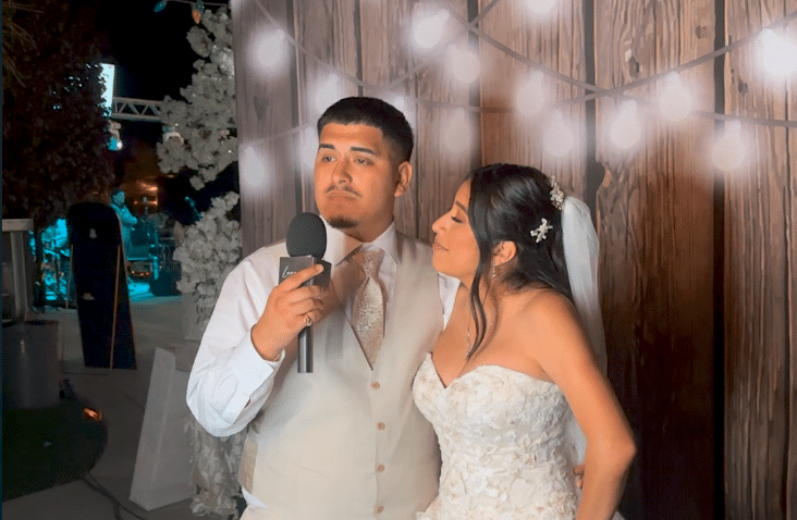 Bride and groom sharing a heartfelt video message inside the Luna Events Confessional Booth at their wedding.