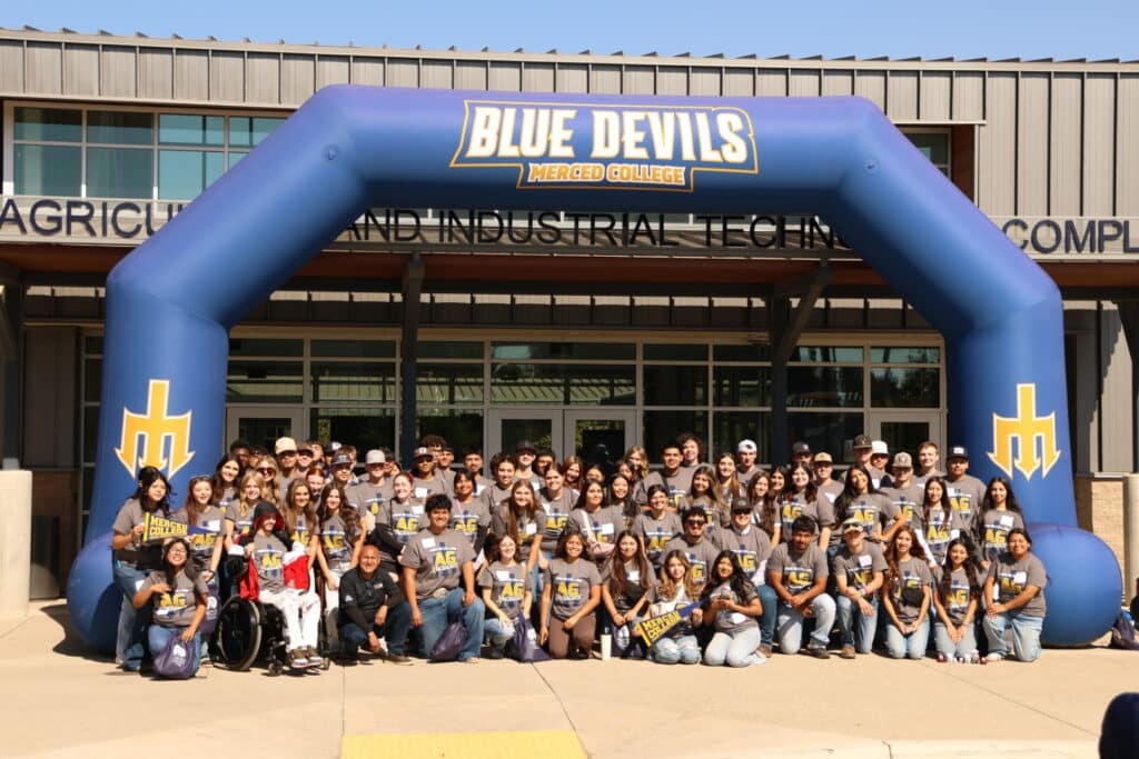 Merced College students posing in front of the Agriculture Building during Agriculture Experience Day in Merced California provided by Luna Events