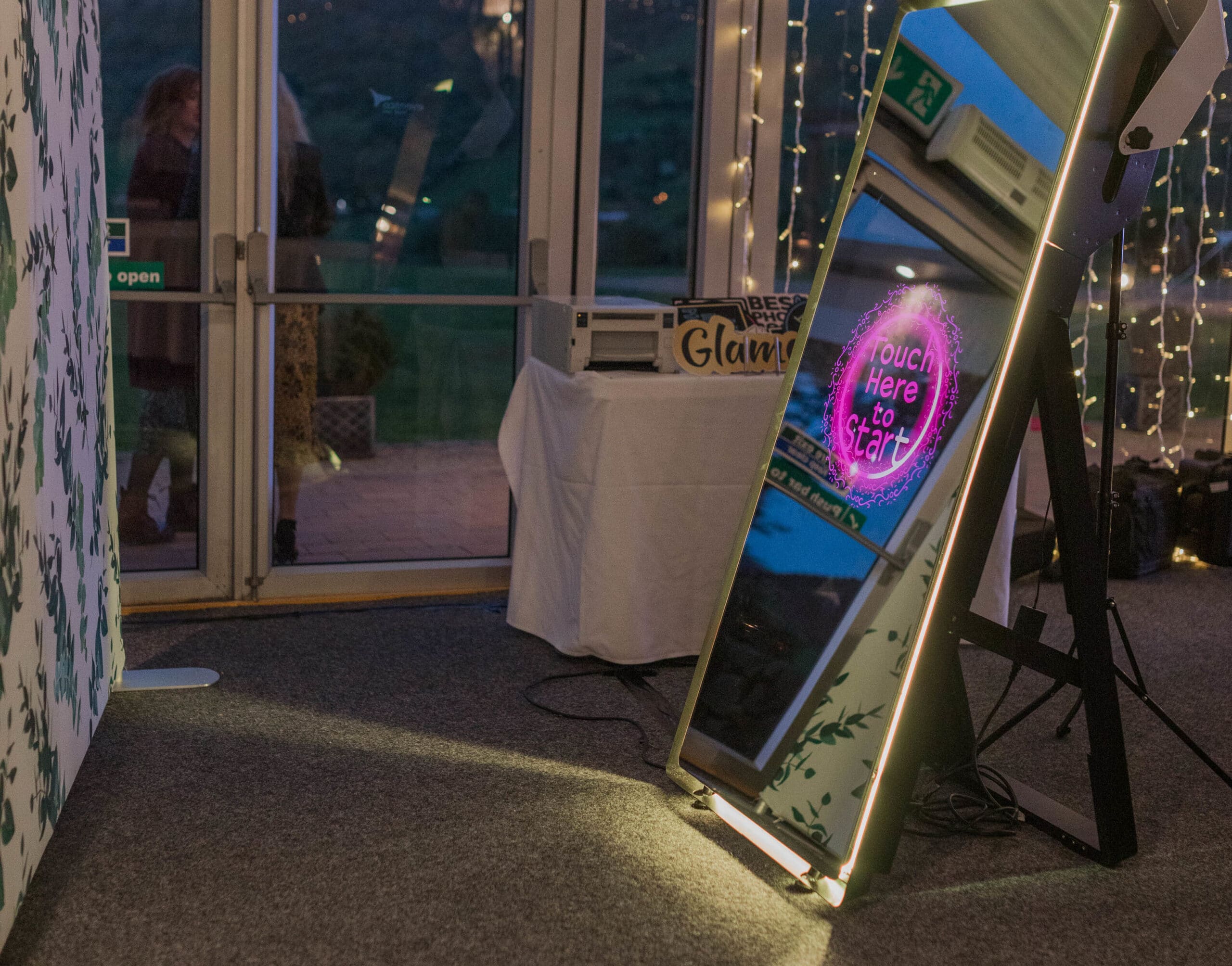 Guests enjoying a Magic Mirror Booth at a wedding, party, or corporate event, taking interactive photos.