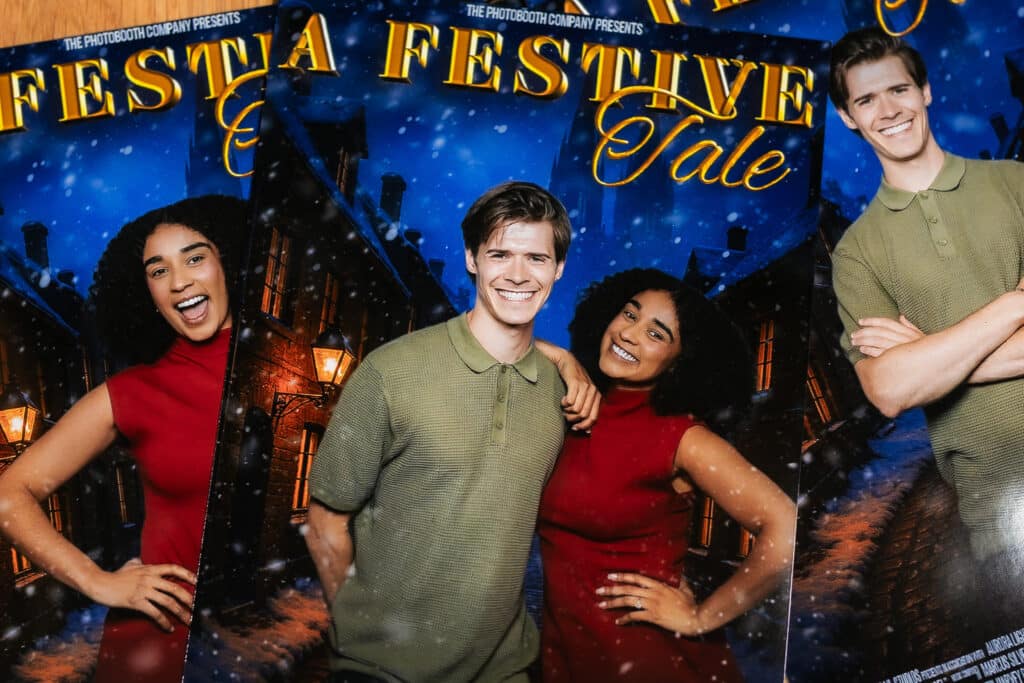 Guests celebrating a holiday event with festive decorations and photo opportunities.