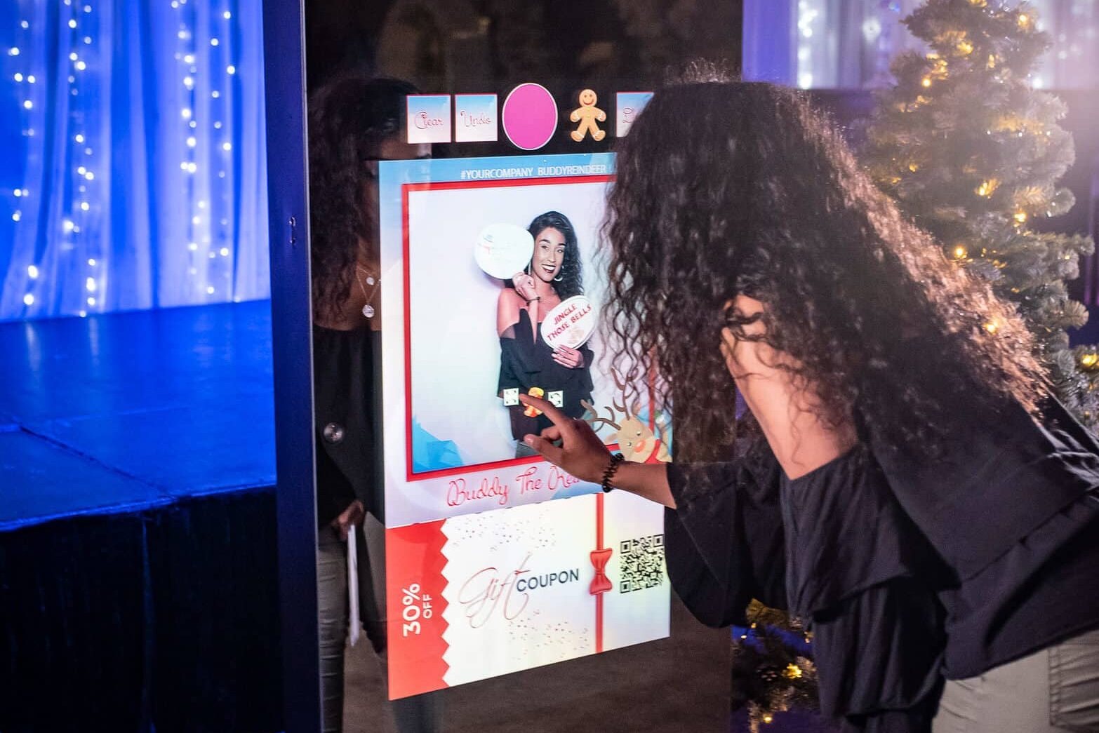 Attendees interacting with a Magic Mirror Booth during a corporate or party event.